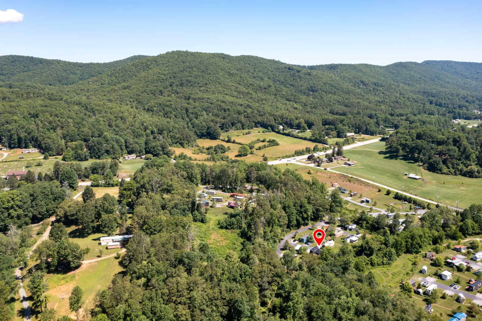 Aerial view showing the tiny home's location in the wooded Acony Bell valley