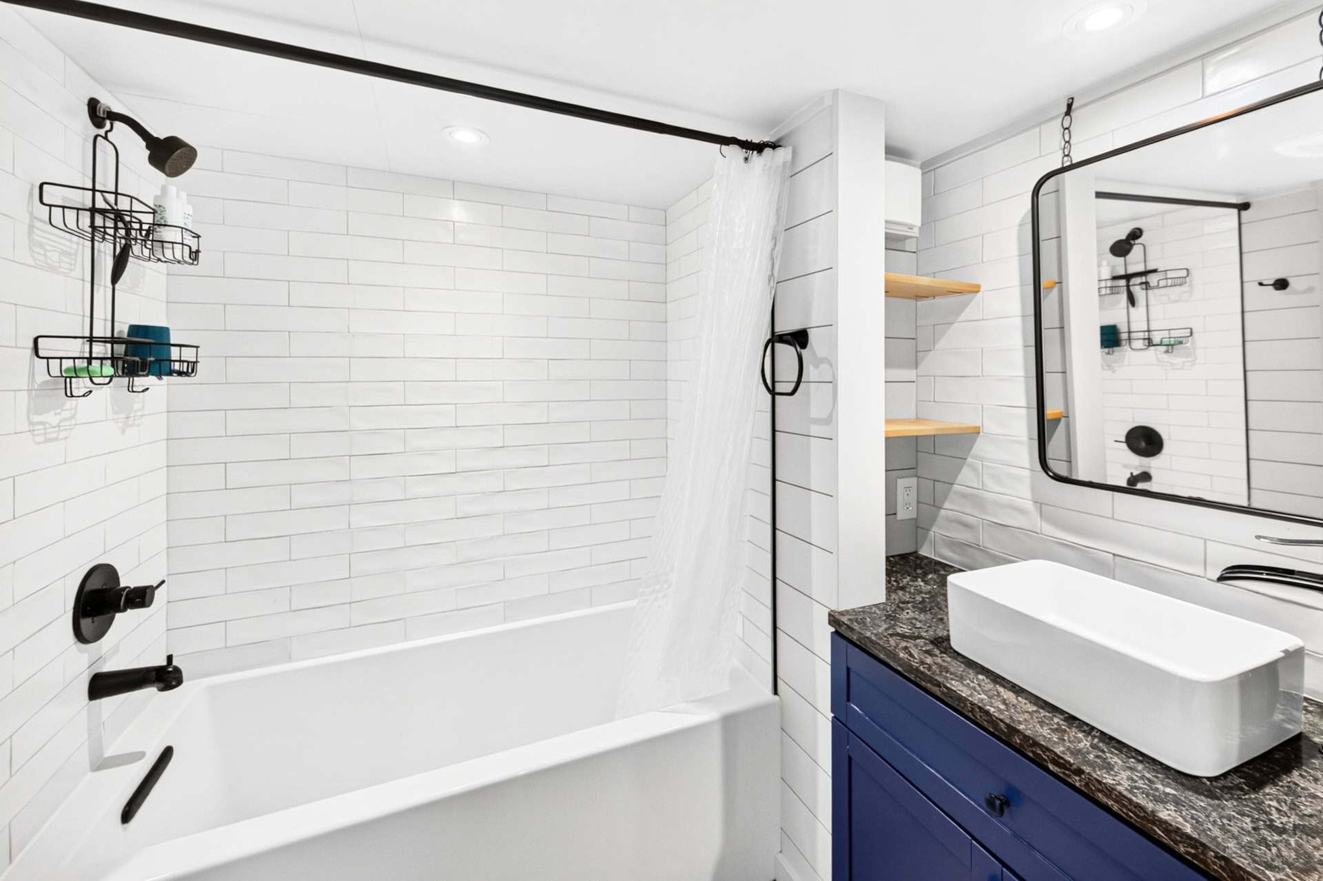Tiny house bathroom with full-size soaking tub and white subway tile