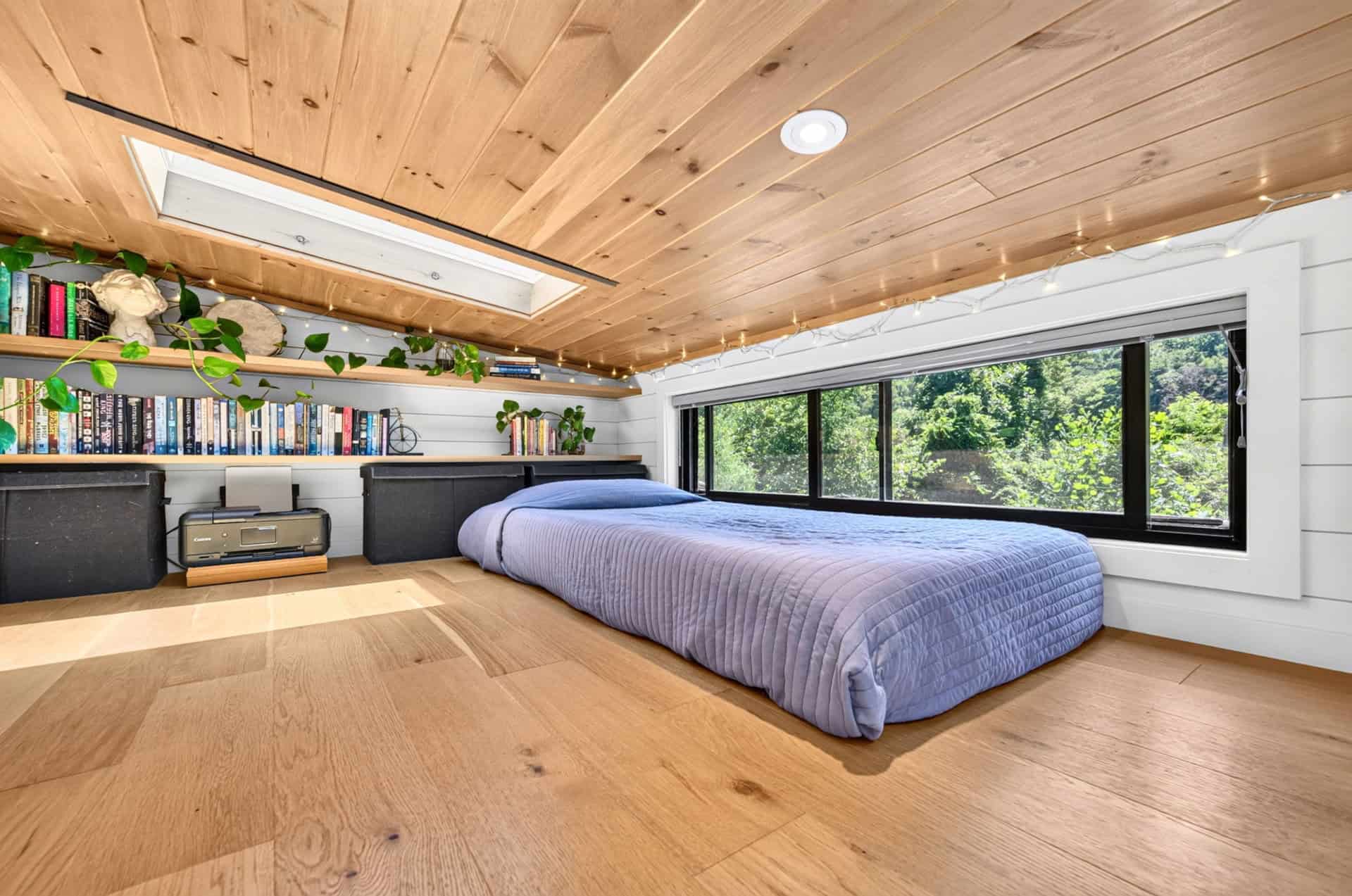 Second loft used as an office and library with built-in bookshelves and skylight