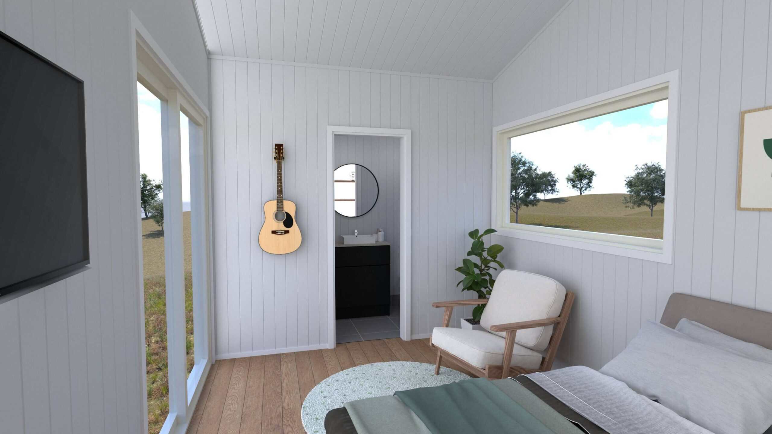 Interior render of the Cub tiny house looking toward the ensuite doorway, with a round mirror and black vanity visible inside, plus an armchair, picture window, and glass entry doors
