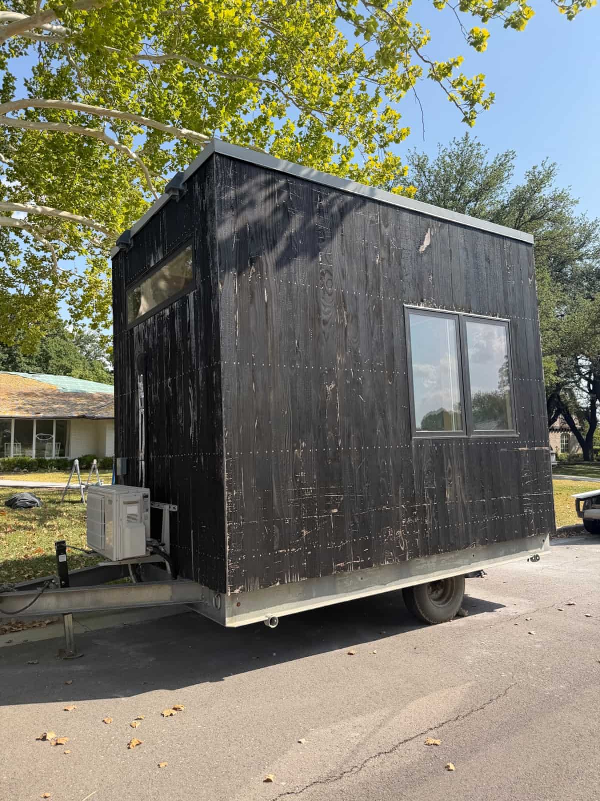 The Cubist Adirondack tiny house for sale in Dallas Texas with mini-split condenser mounted on the exterior