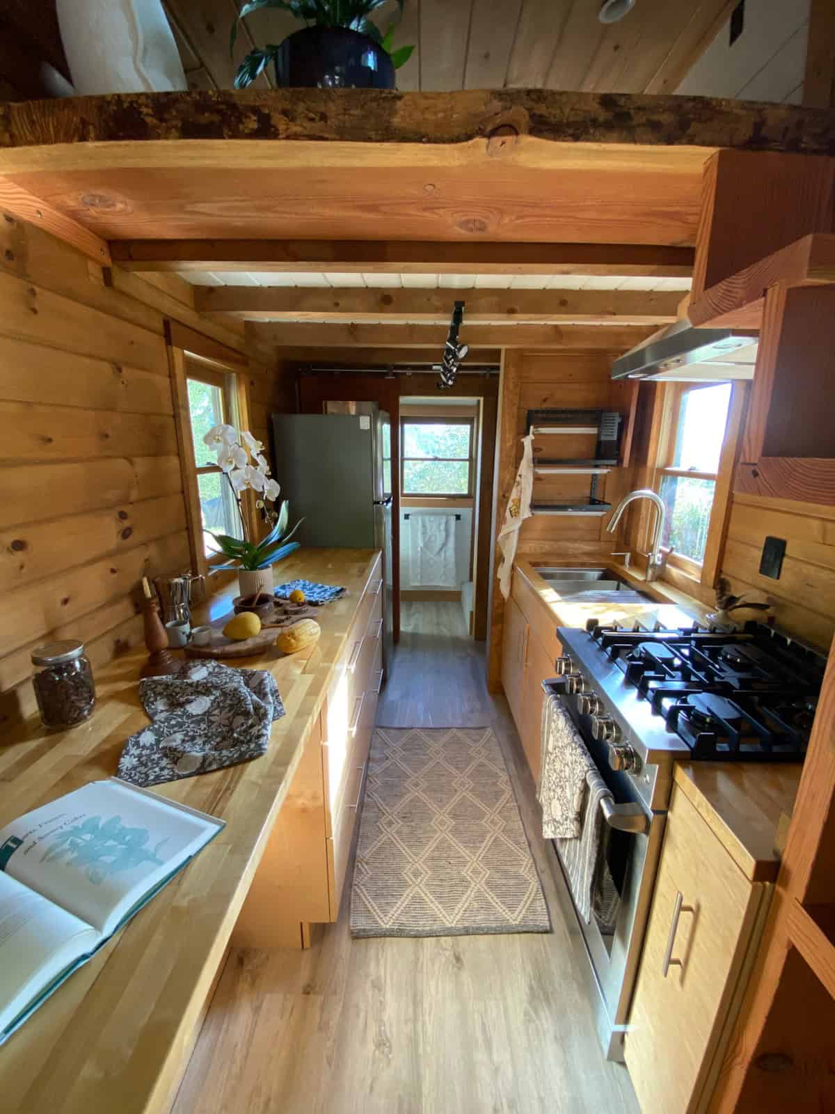 Galley kitchen with birch butcher block counters, propane range, and custom cabinets