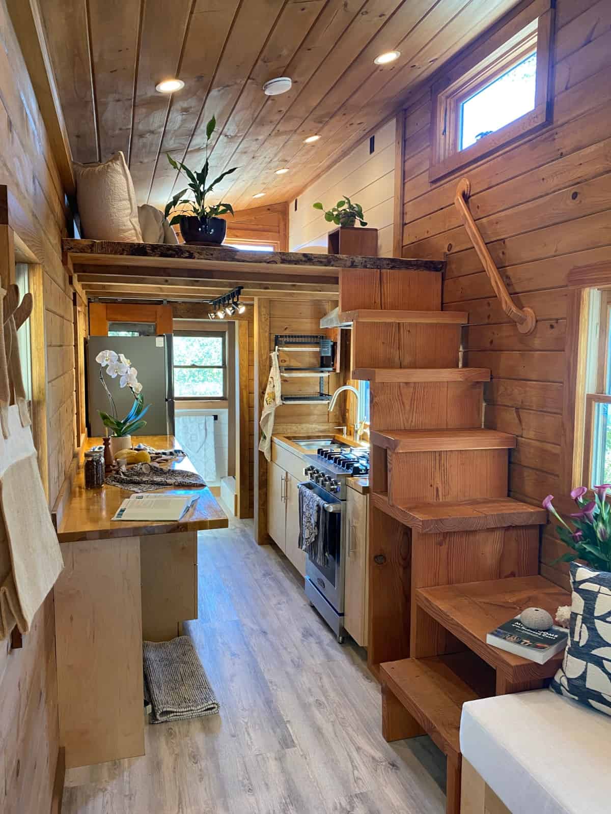 Custom timber storage stairway with handrail leading to the master loft above the kitchen