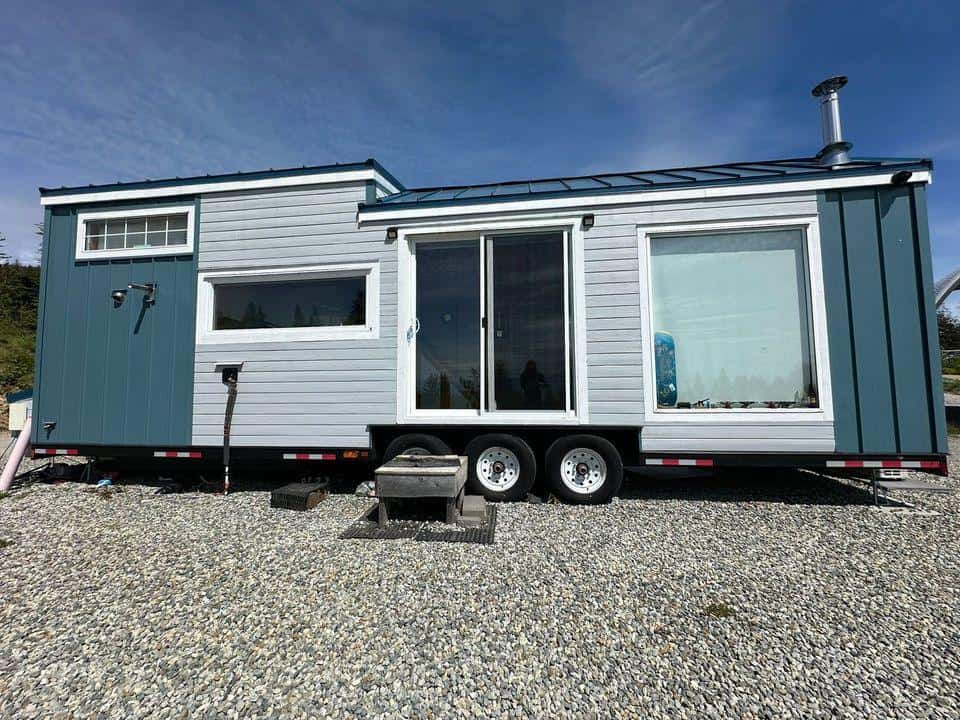 Elegant tiny house built by a skilled cabinet maker, showcasing custom craftsmanship and efficient s.