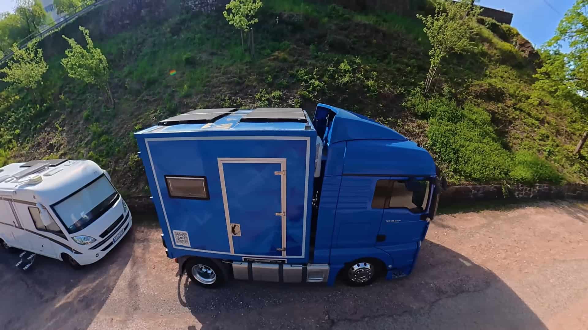 Aerial view of the DIY truck tiny house showing three solar panels on the roof and compact 6-meter footprint