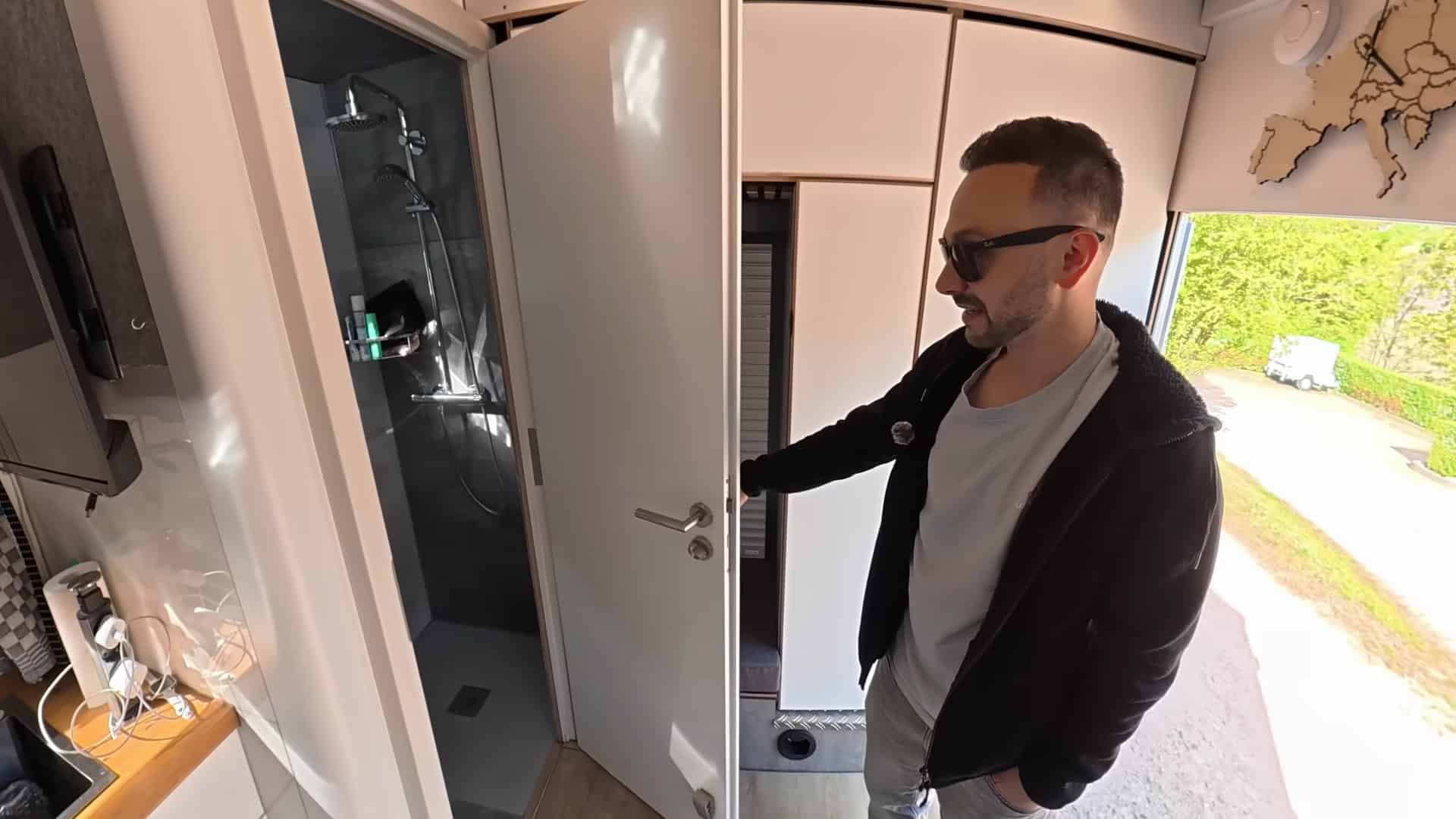 Pass-through roller door connecting the driver cab to the living space in the semi-truck tiny house
