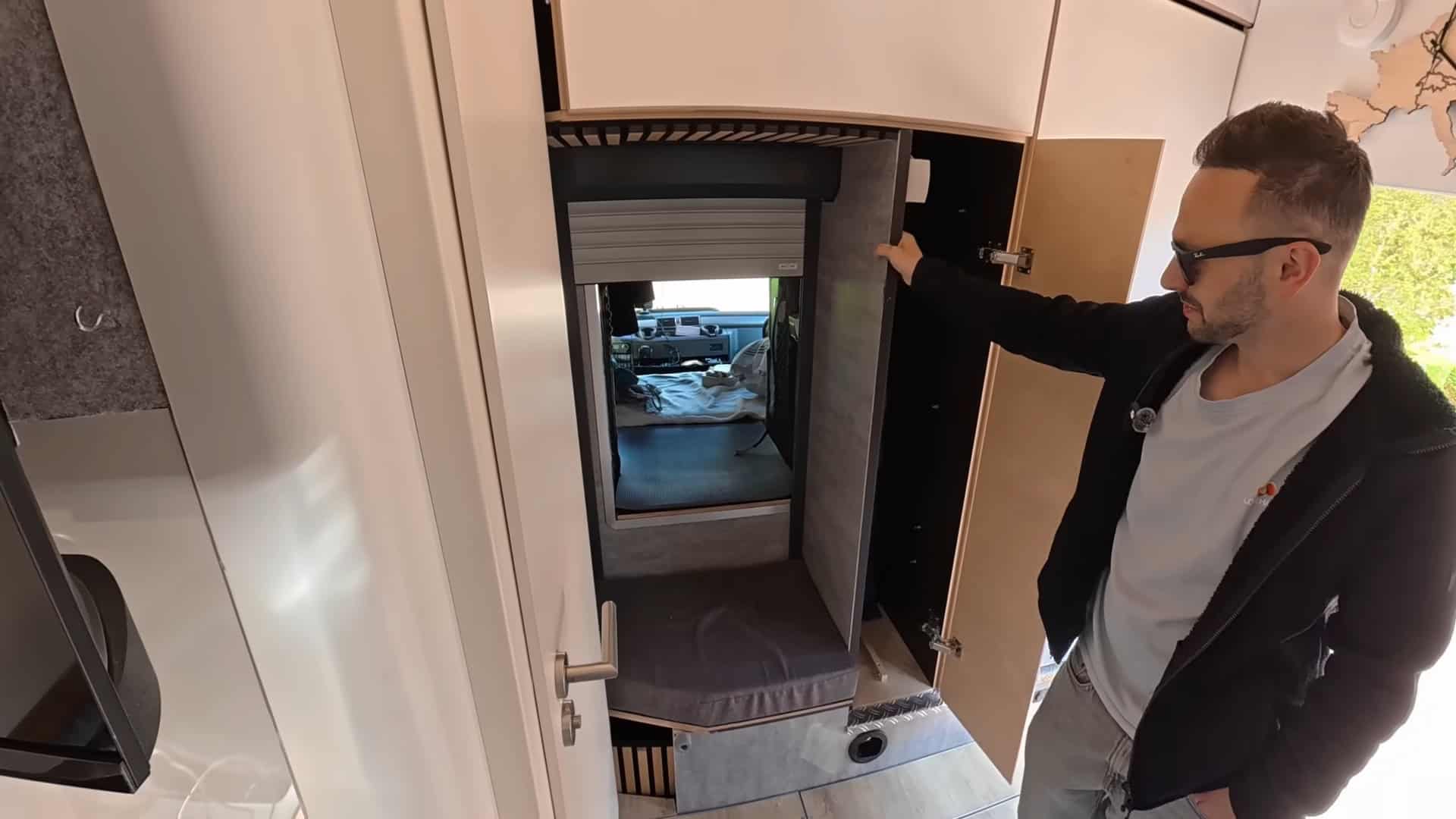 Roller shutter open showing the pass-through from living space into the cab bunk sleeping area