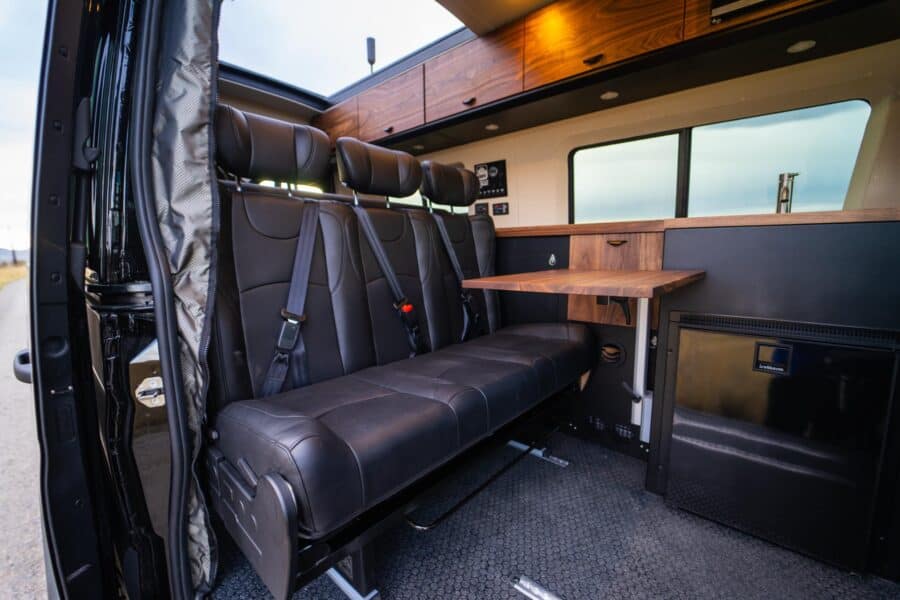 Efficient van interior with comfortable seating and workspace for family travel.