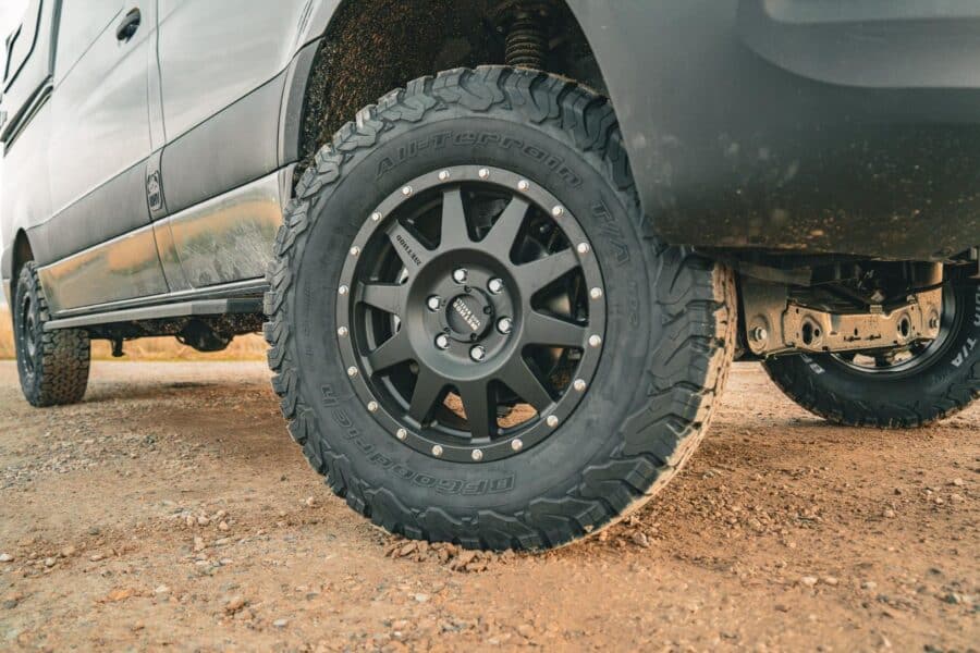 All-terrain tire on a family van conversion for off-road adventures.