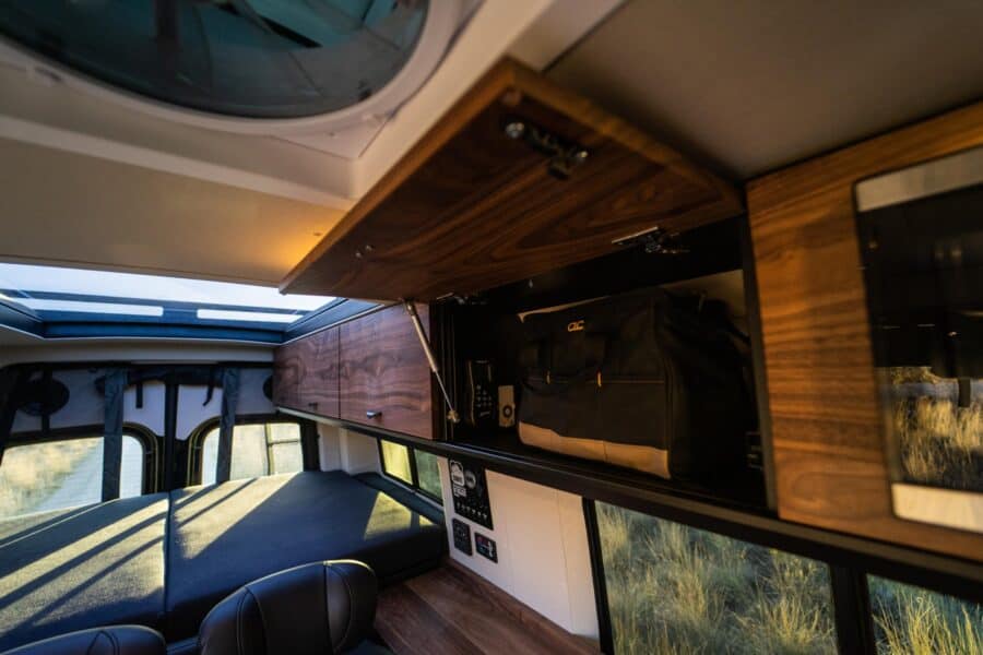 Compact family van interior with custom storage and cozy sleeping area.