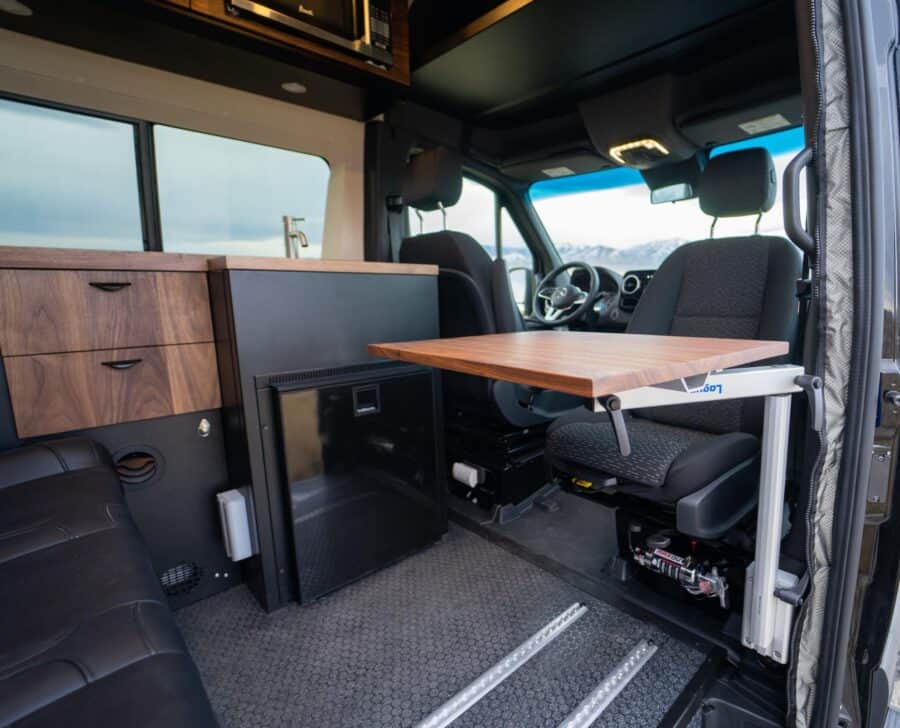 Interior of a family van converted for tiny living and travel.
