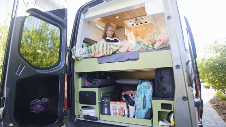 Compact van conversion with wet bath and dishwasher for efficient downsizing.