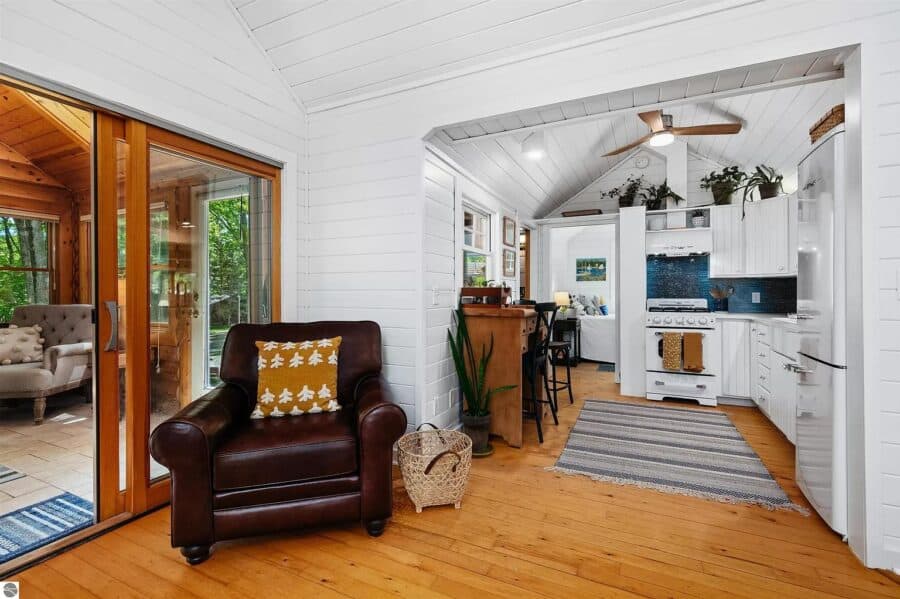 Charming tiny log cabin interior with white walls, wooden accents, and modern kitchen in Northern Mi.