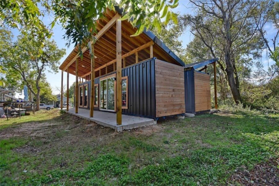 Shipping container tiny house with modern design and outdoor deck in Brenham, Texas.