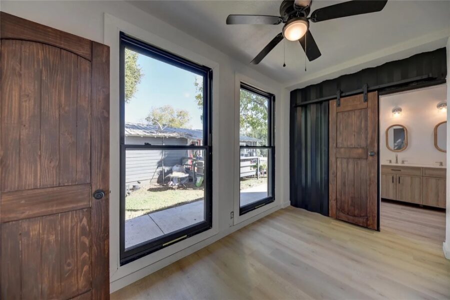 Bright interior with large windows and modern decor in a Brenham shipping container home.