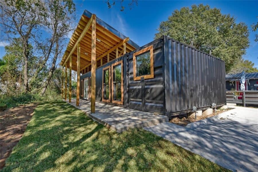 Shipping container home with modern design and outdoor deck in Brenham, Texas.