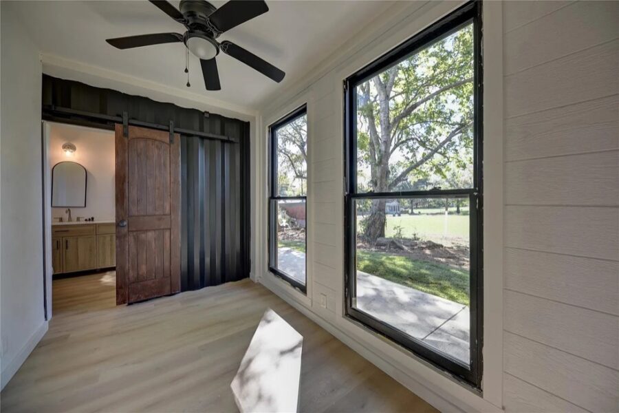 Modern shipping container home with bright windows and minimalist design in Brenham, Texas.