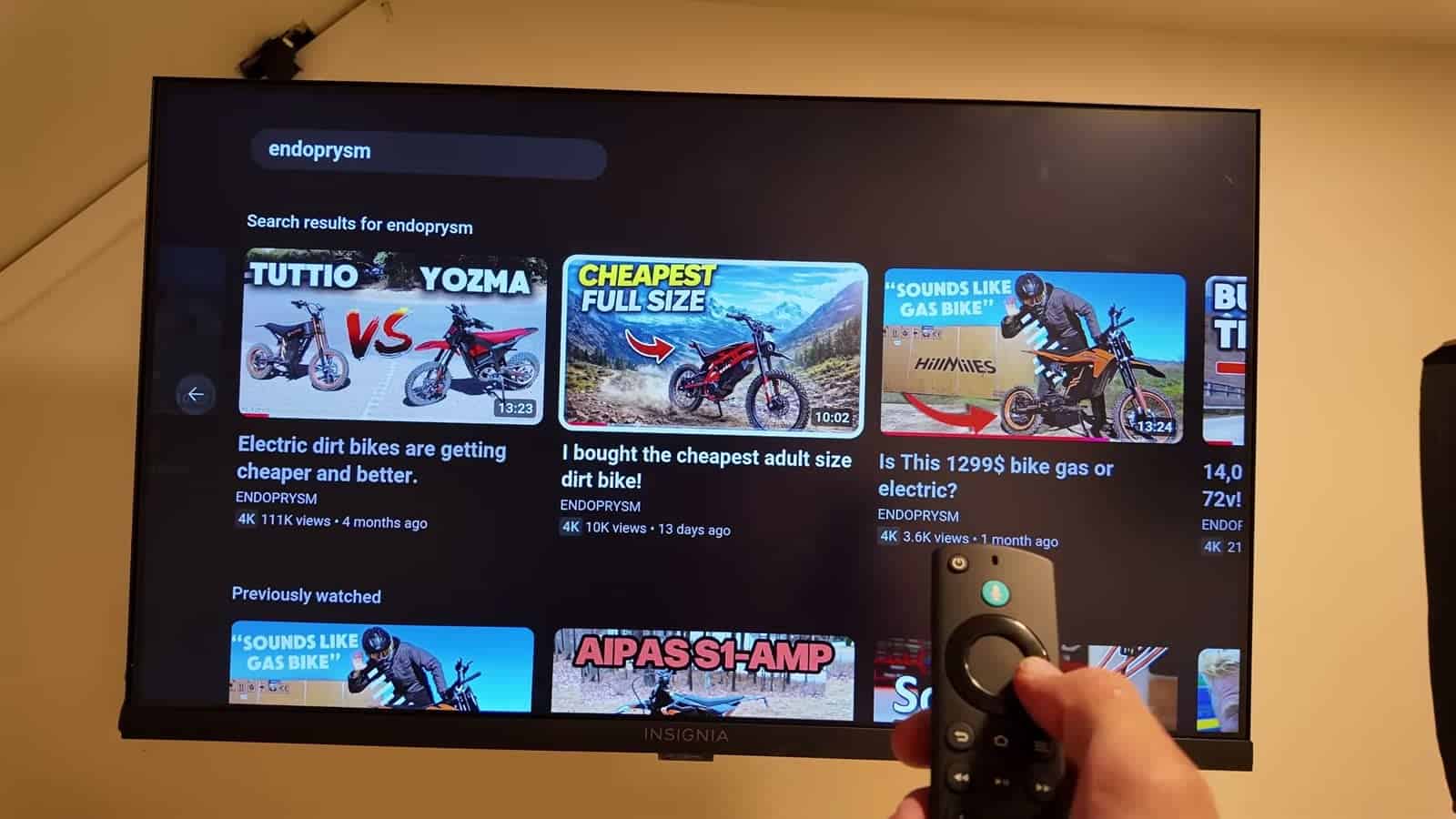 TV inside the e-bike camper streaming YouTube with a remote in hand