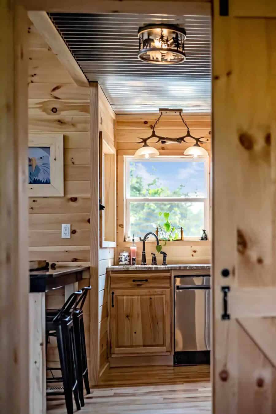 Charming small kitchen in Eagles Nest Cabin with natural wood finishes and modern appliances.