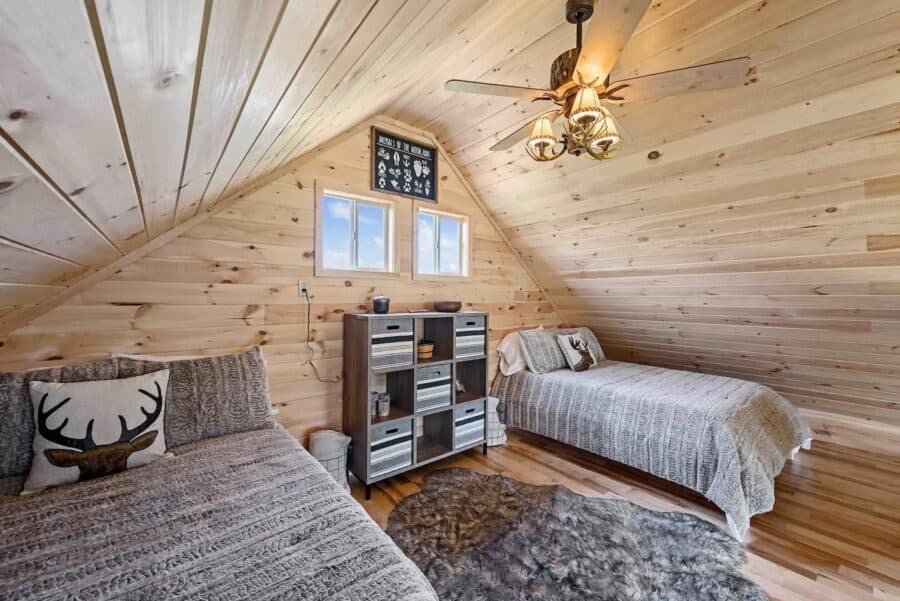 Interior view of Eagles Nest Cabin in West Virginia with rustic wooden decor and cozy sleeping areas.