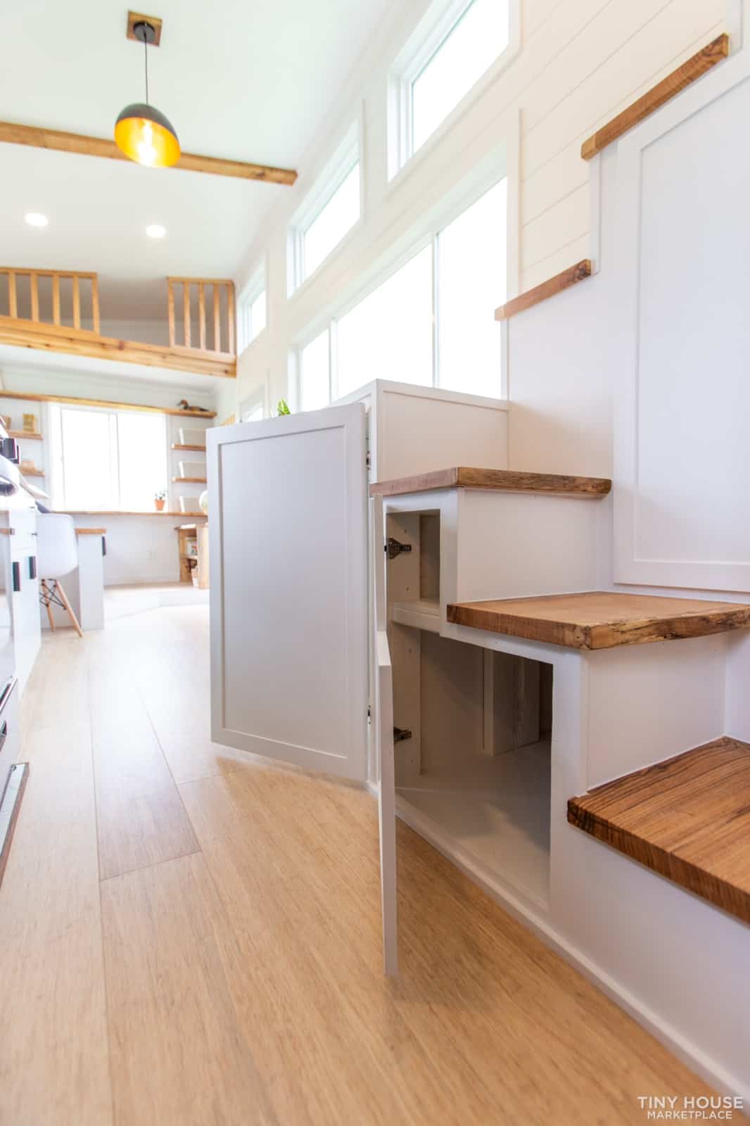 Open storage cabinet built into the side of the Elderberry's switchback staircase