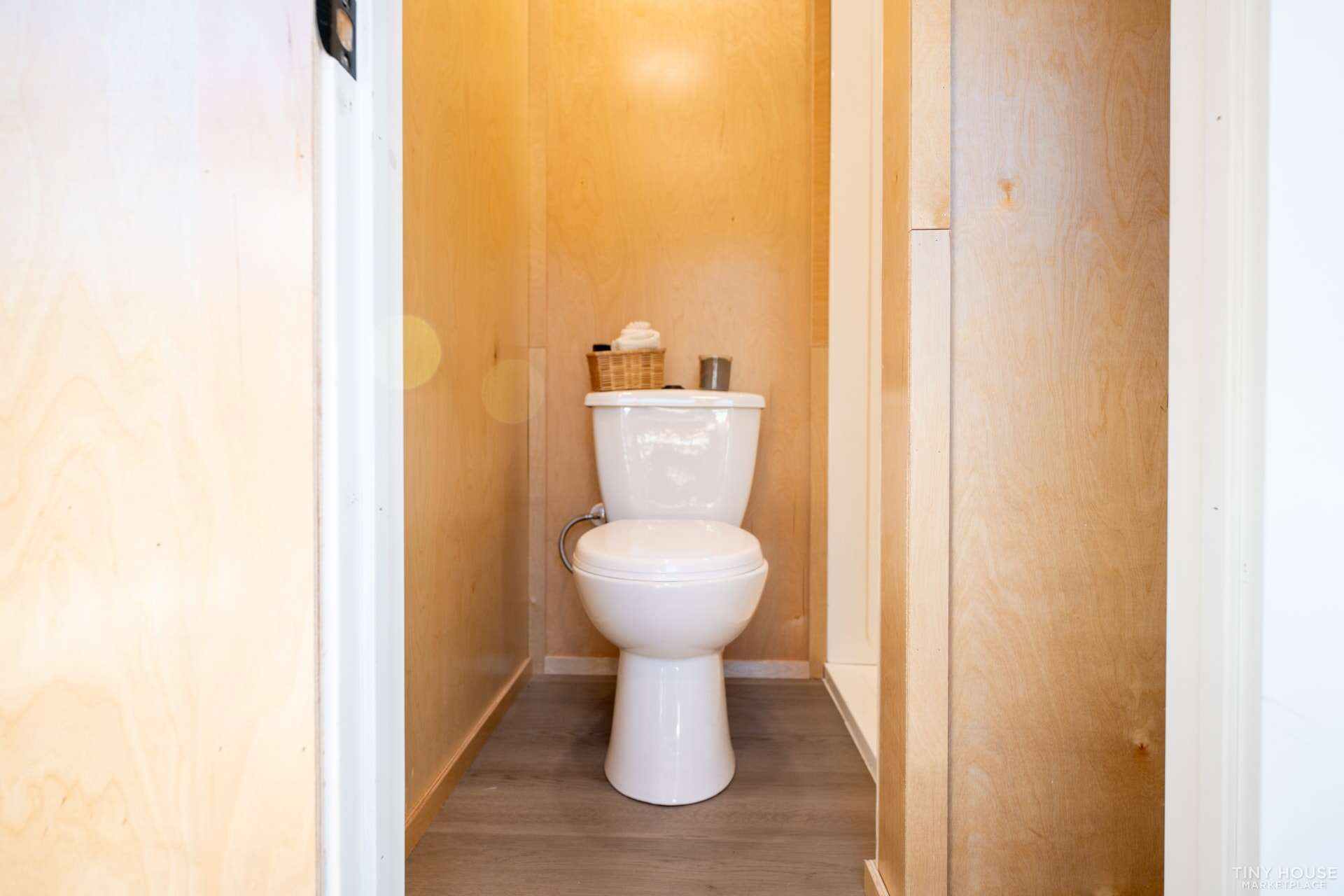 Small bathroom with a toilet in a tiny house, minimalist design.