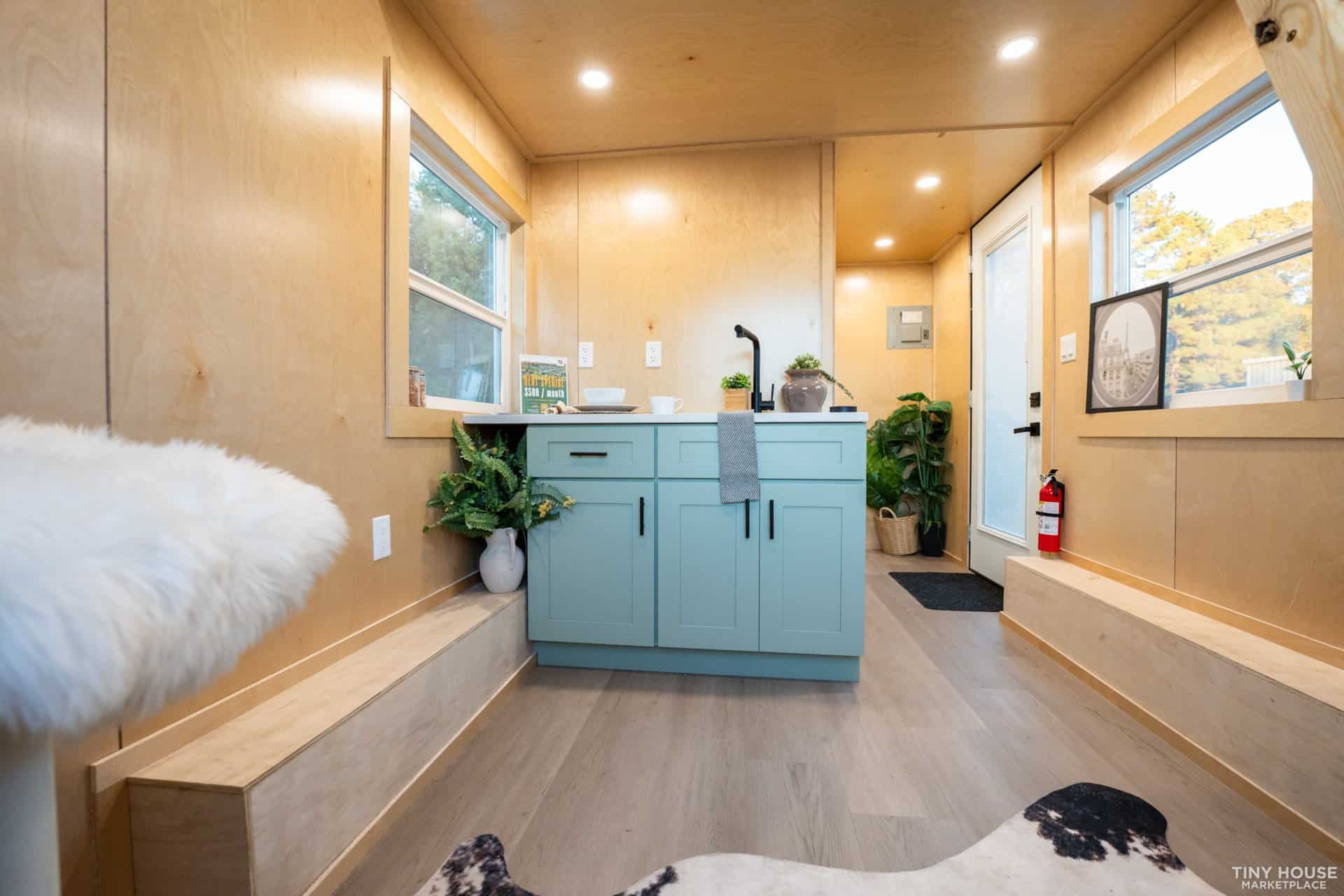 Element 16 Pro kitchen with sage blue cabinets, quartz countertops, and black fixtures