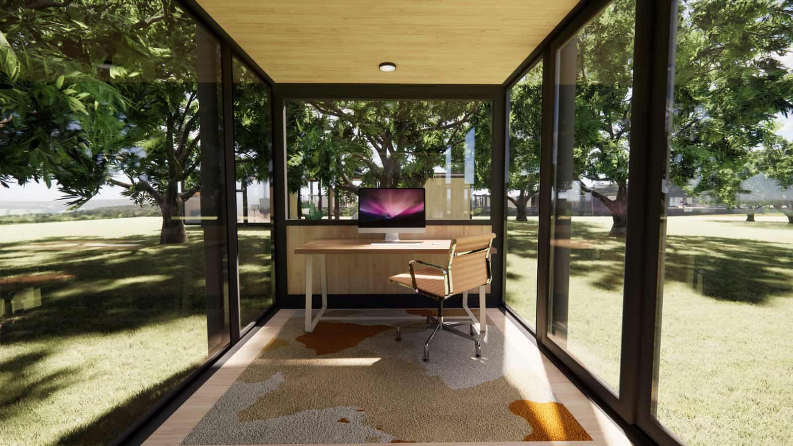 Interior of the Elsewhere Pods micro home configured as a home office with desk and glazing on three sides