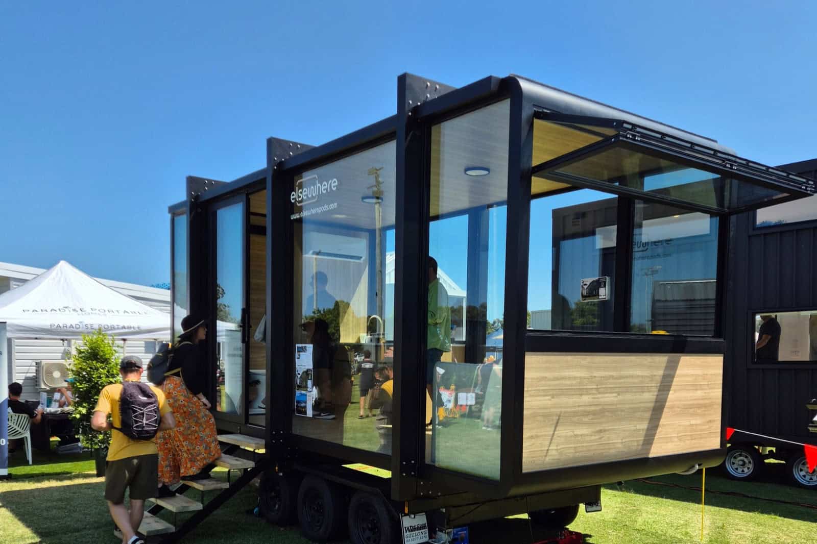 Three-quarter view of the Elsewhere Pods 6m Tiny Home with the large bifold window propped open
