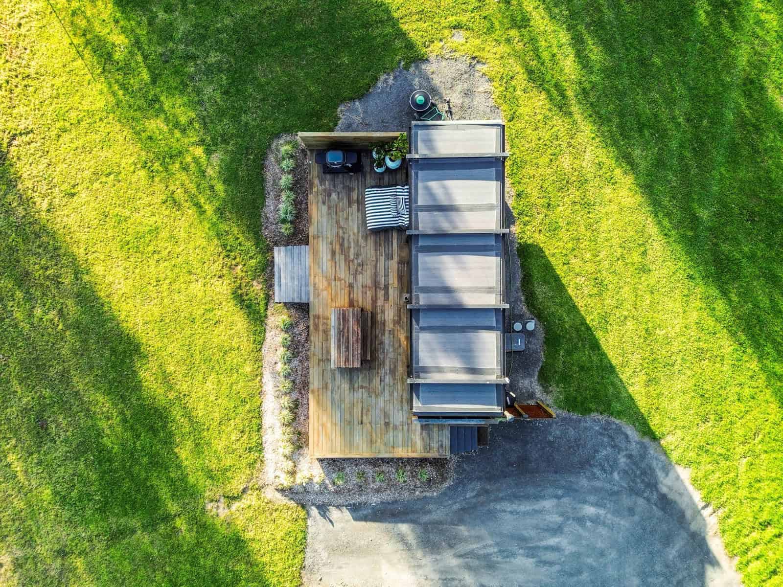 Aerial view showing the 8m pod, its adjoining deck, gravel apron, and surrounding paddock