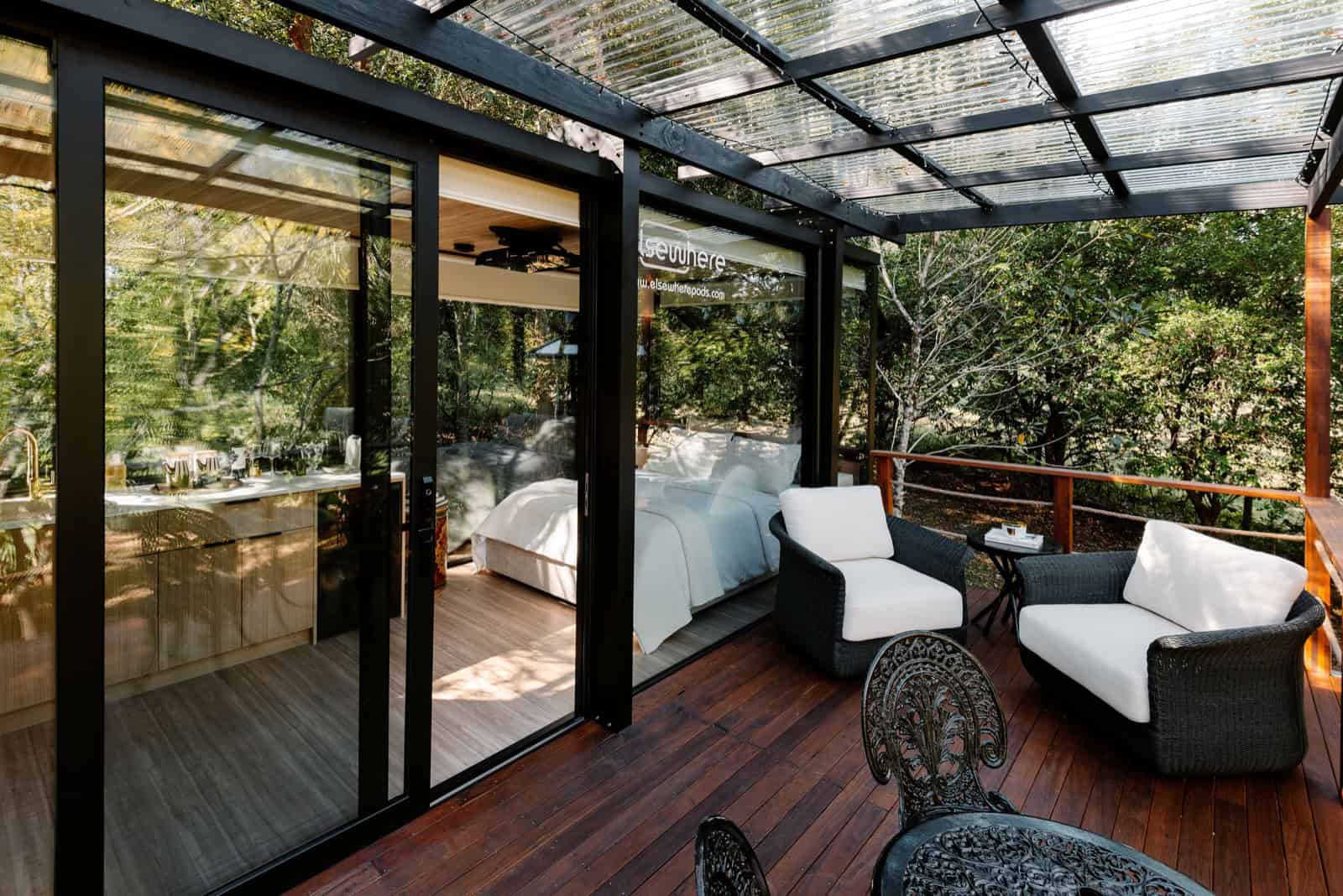 Elsewhere Pods 6m tiny home at Peachester with the slider open onto a hardwood deck in rainforest