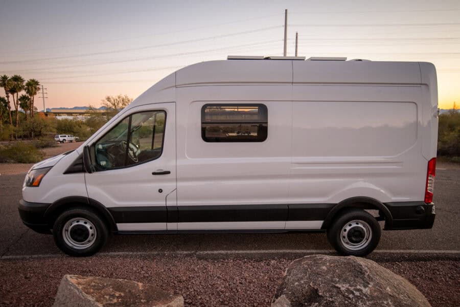 Compact van converted for tiny house living with efficient design and large pantry.