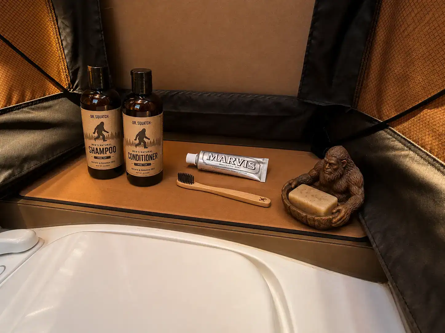 Toiletry shelf inside the 12RK-FB bathroom module with a Bigfoot soap dish and grooming supplies