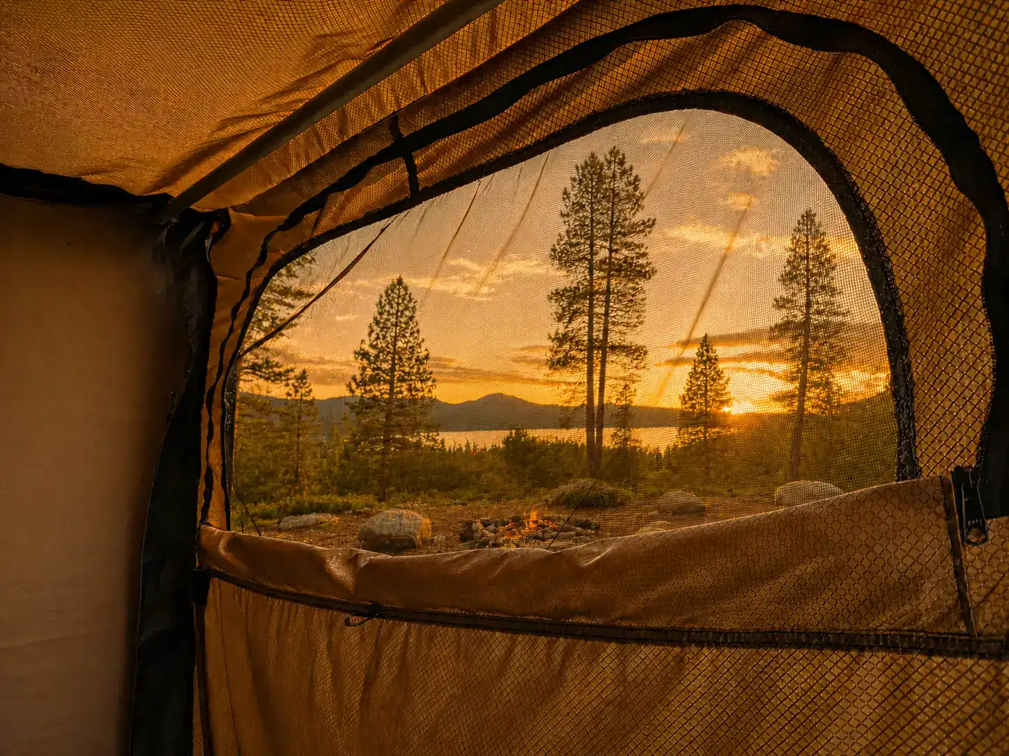 Sunset lake view through the screened window of the Encore RV ROG 12RK-FB bathroom module