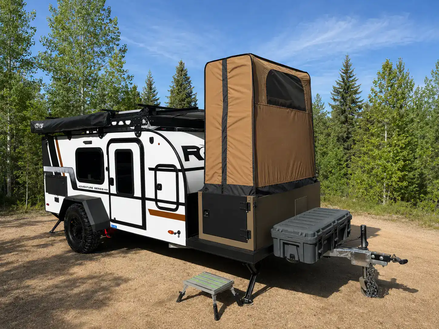 Encore RV ROG 12RK-FB off-road travel trailer parked in the forest with the rear bathroom module deployed