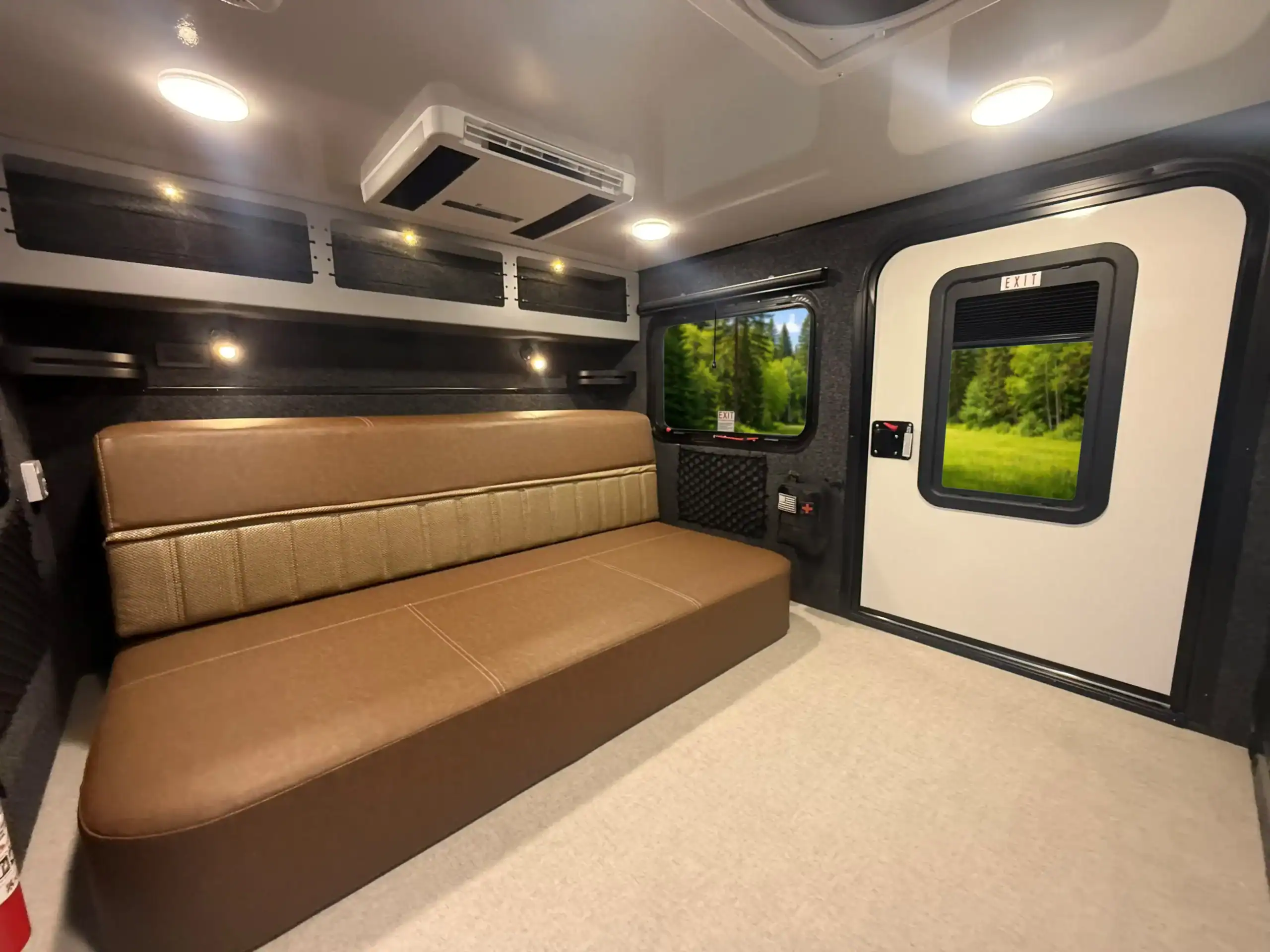 The convertible futon couch inside the Encore RV ROG 12RK-FB in seating position
