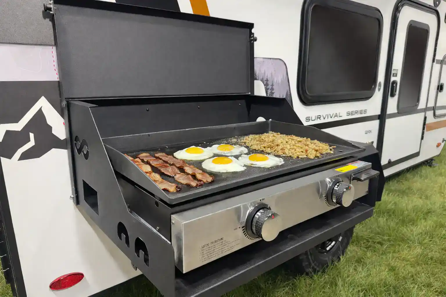 Breakfast cooking on the flip-down griddle station of the Encore RV ROG 12RK-FB