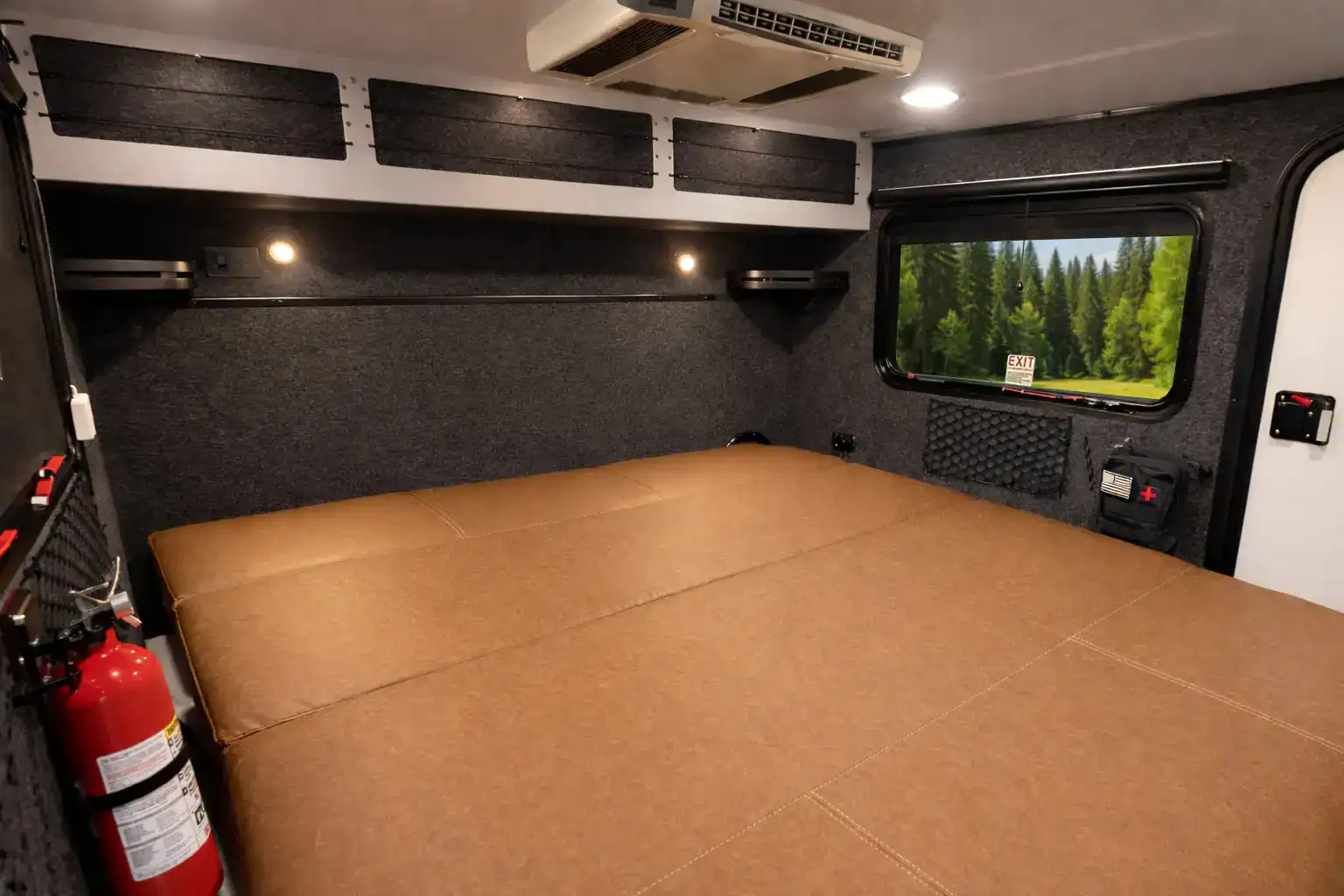 The Encore RV ROG 12RK-FB interior with the futon laid flat into a queen bed