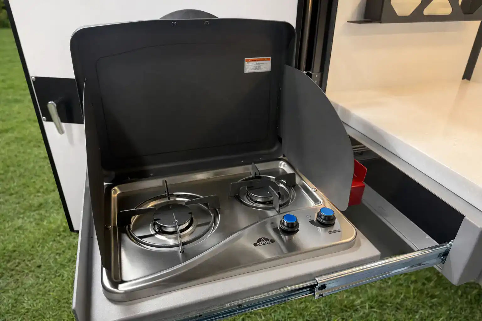 The slide-out stove on the Encore RV ROG 12RK-FB rear outdoor kitchen