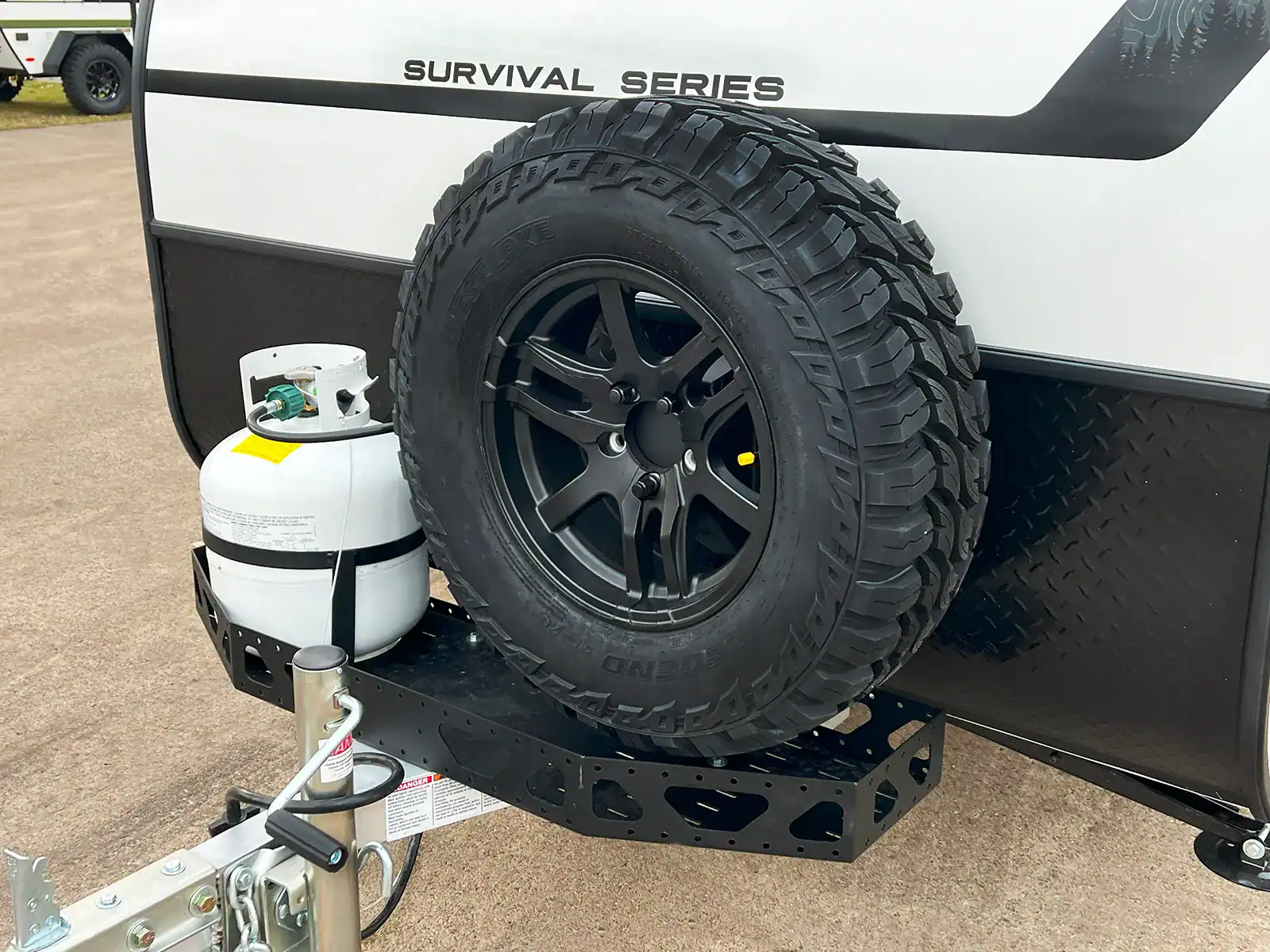 The front-mounted spare tire and LP carrier on the Encore RV ROG 12RK-FB