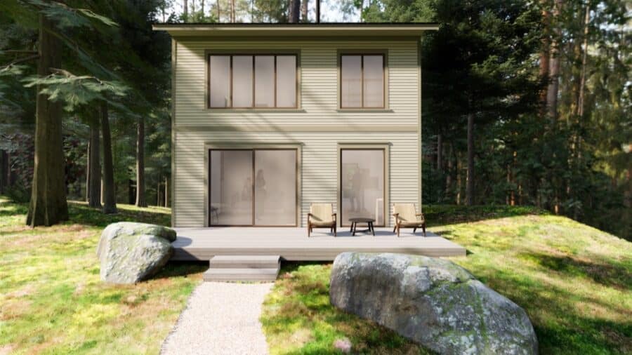 Modern tiny cabin nestled in a lush forest setting with a small deck and outdoor seating.