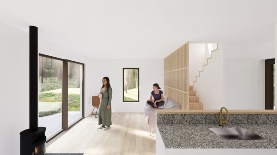 Modern tiny home interior with large windows and minimalist design in a forest setting.