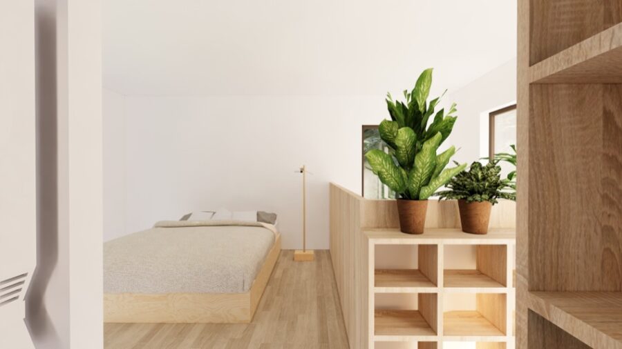 Bright and minimalist tiny home bedroom with natural wood accents and lush green plants.