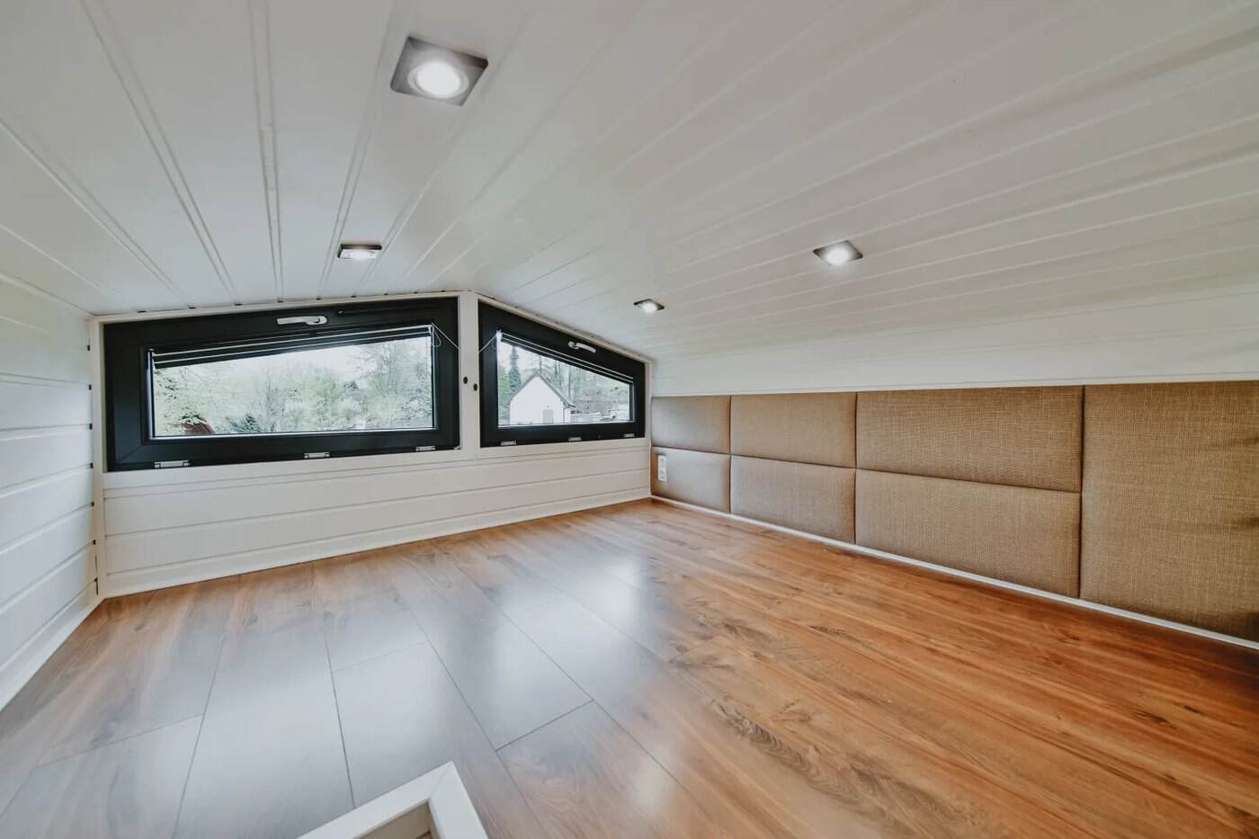 Mezzanine bedroom in the Scandinavian Erica build with padded wall panels and clerestory windows