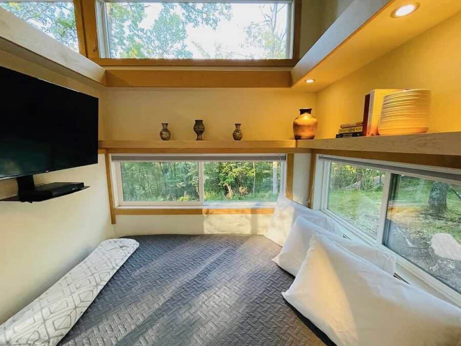 Upgraded Escape Traveler XL tiny house interior with large windows and cozy decor for small space li.