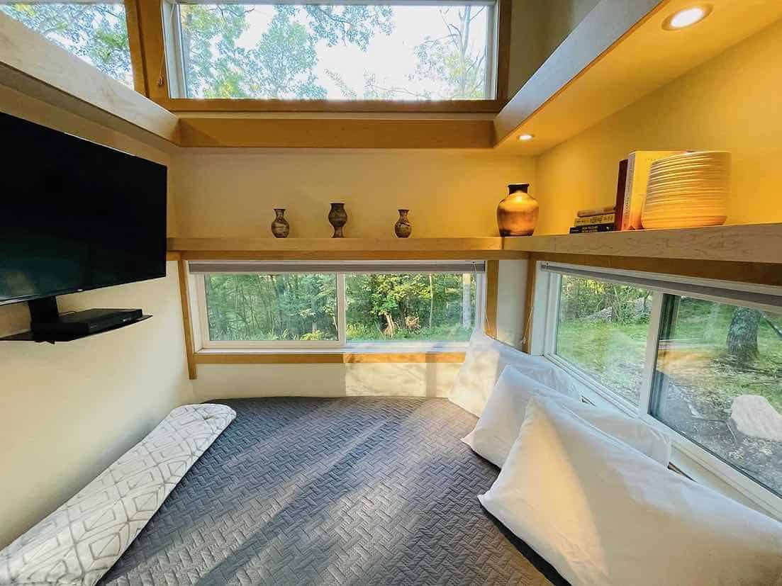 Tiny House Interior with Large Windows and Cozy Design