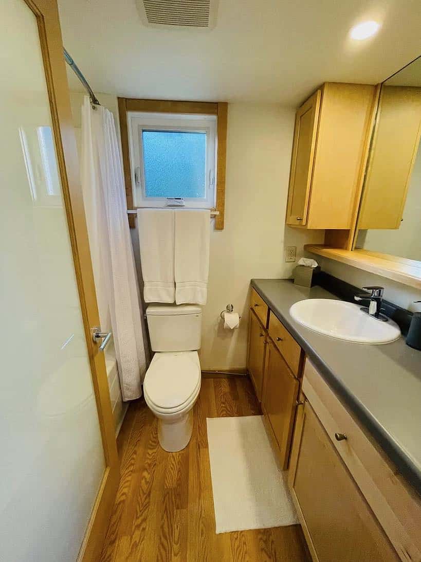 Bathroom in a tiny house with compact fixtures and natural wood accents.