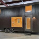 Tiny House on Wheels with Sleek Black Exterior.