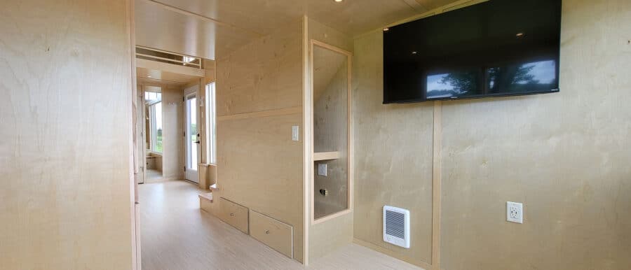 Interior of a modern tiny house with minimalist decor and efficient space use.