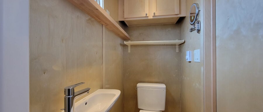 Bathroom in a tiny house with compact sink and toilet.